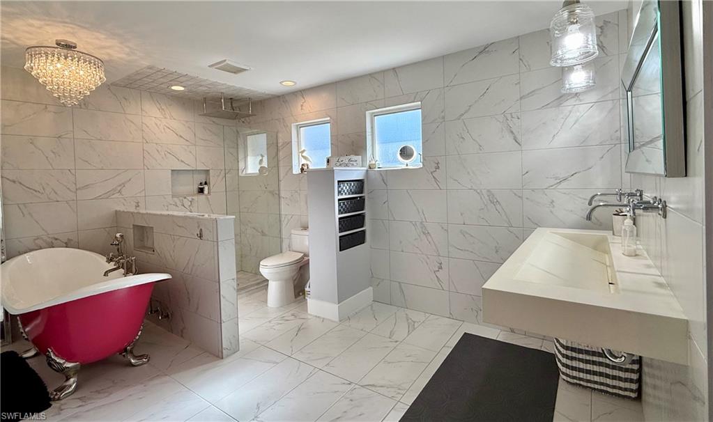 2120 Sandpiper Street Naples, FL 34102 - Photo 22 of 48 master bath, stand alone tub, shower, double floating sink