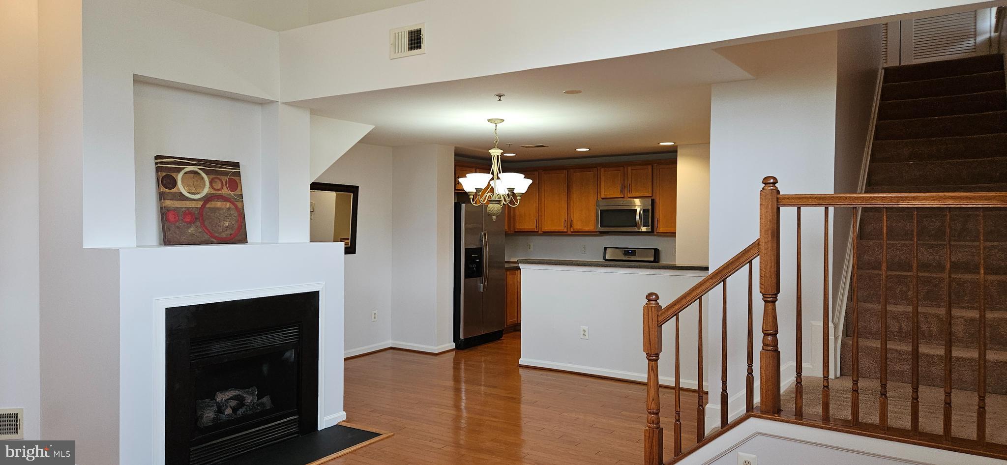 12332 Rollys Ridge Avenue, Unit 2105 Upper Marlboro, MD 20774 - Photo 11 of 31 a view of a hallway with wooden floor and staircase