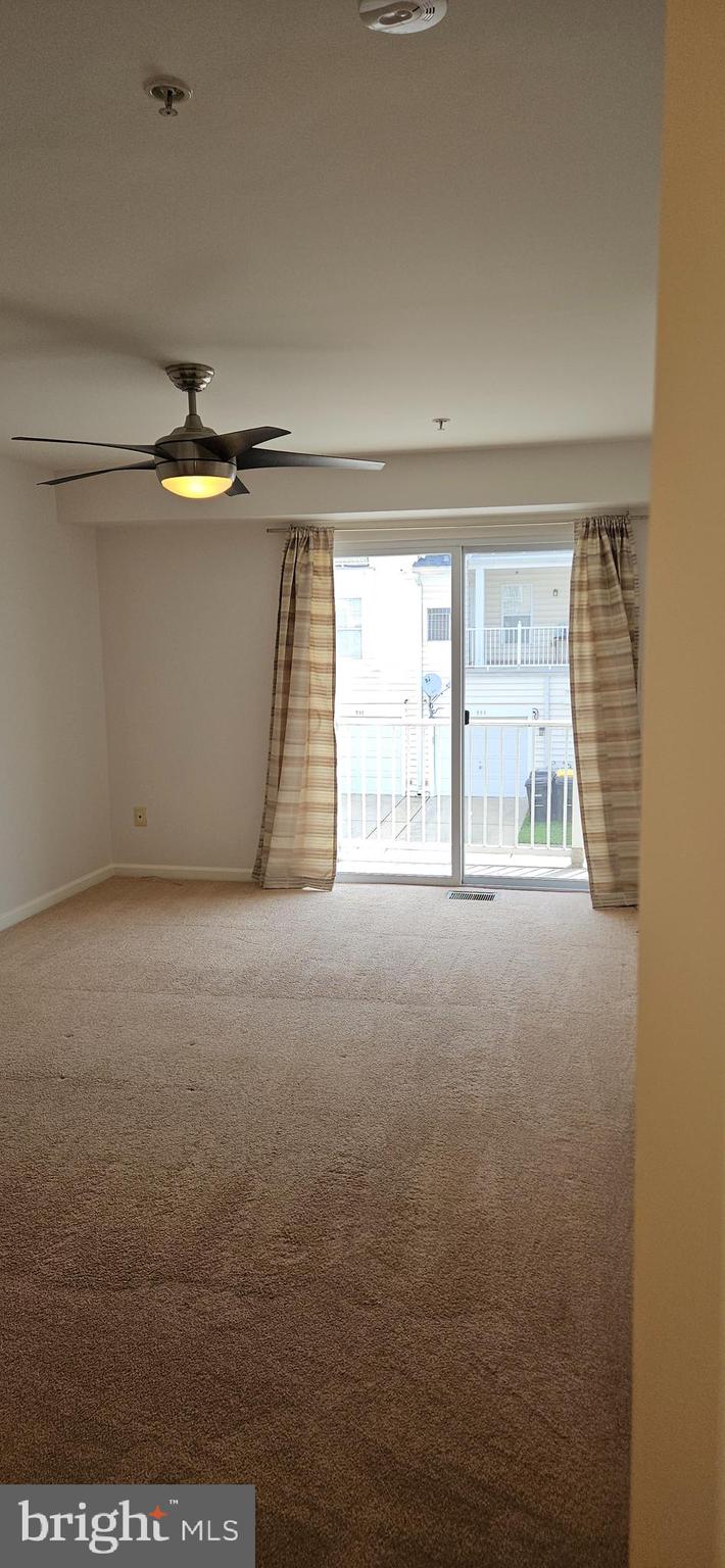 12332 Rollys Ridge Avenue, Unit 2105 Upper Marlboro, MD 20774 - Photo 19 of 31 a view of an empty room with a window
