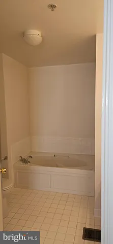 a white toilet sitting next to a shower