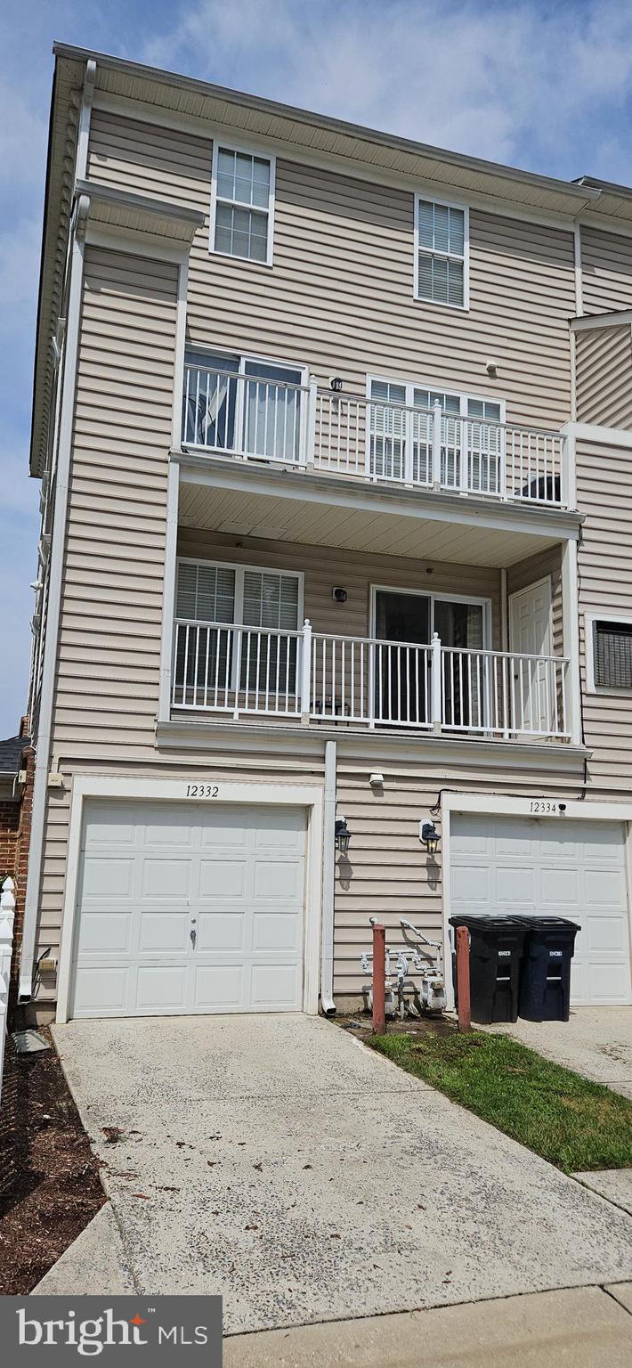 12332 Rollys Ridge Avenue, Unit 2105 Upper Marlboro, MD 20774 - Photo 29 of 31 a front view of a house with a yard and garage