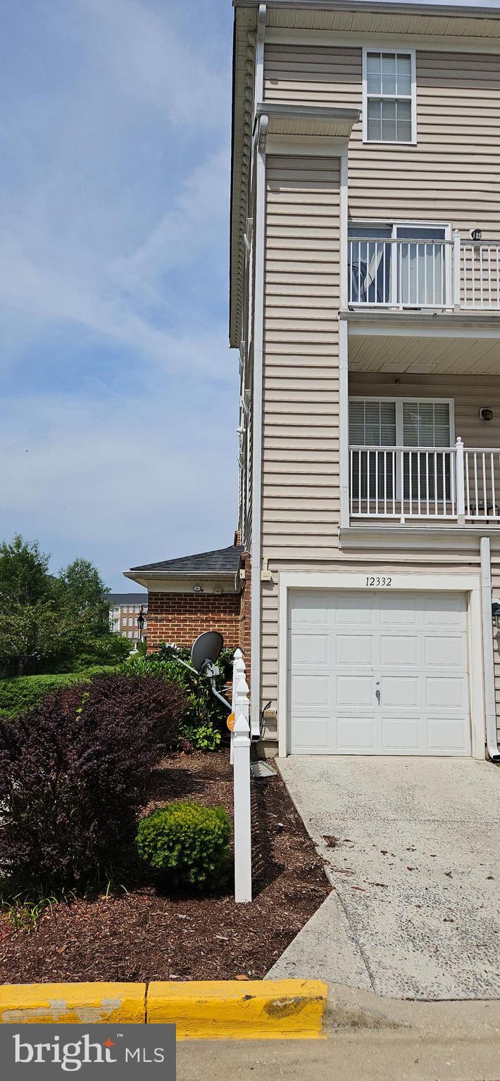 12332 Rollys Ridge Avenue, Unit 2105 Upper Marlboro, MD 20774 - Photo 30 of 31 a view of a house with a yard