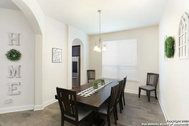 a view of a dining room with furniture and wooden floor