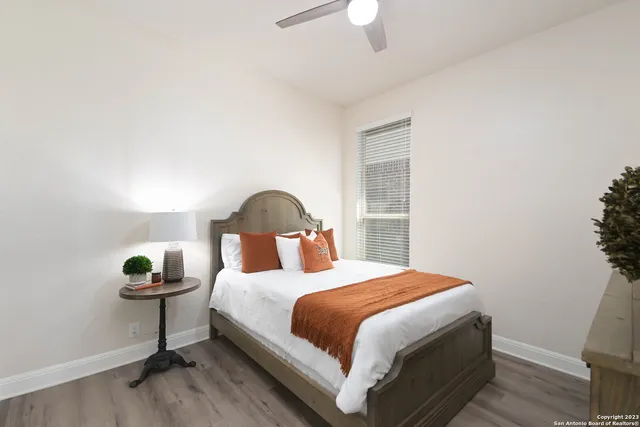 a bedroom with a bed and a lamp