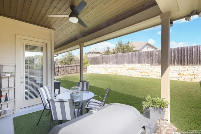 a balcony with furniture and a garden