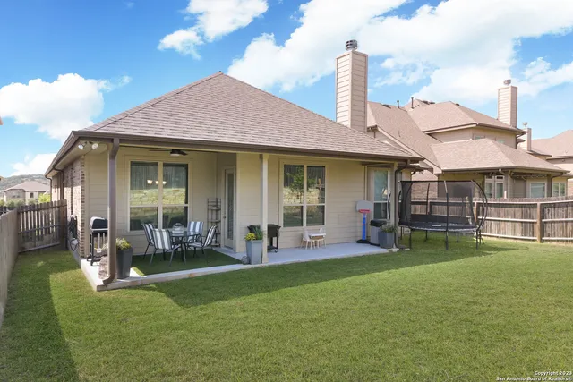 a front view of a house with a garden and plants
