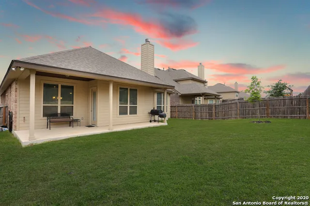 a view of a house with a backyard
