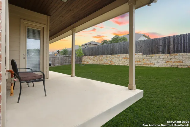 a view of a porch with furniture and backyard