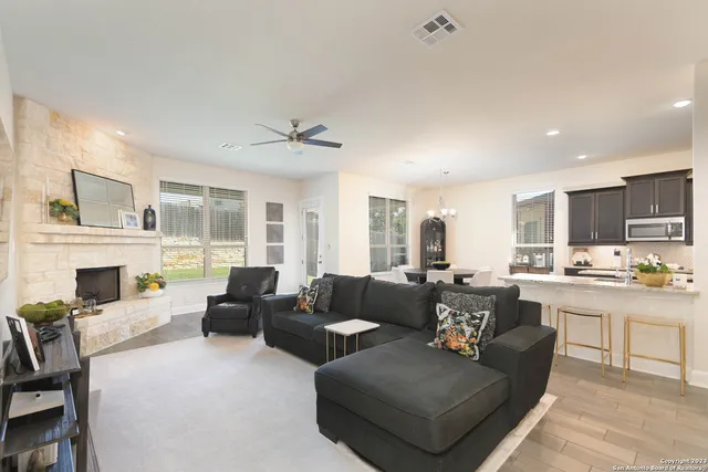 a living room with furniture fireplace and a view of kitchen