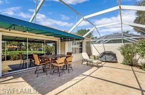 3687 El Segundo Court Naples, FL 34109 - Photo 14 of 17 a view of a patio with a dining table and chairs