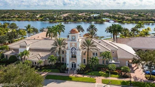 an aerial view of a residential houses with outdoor space and lake view