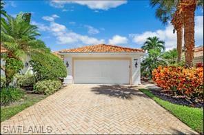 3687 El Segundo Court Naples, FL 34109 - Photo 5 of 17 a front view of a house with a yard and garage