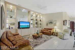 3687 El Segundo Court Naples, FL 34109 - Photo 9 of 17 a living room with furniture and a flat screen tv