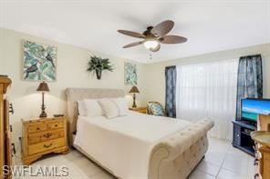 3687 El Segundo Court Naples, FL 34109 - Photo 10 of 17 a bedroom with a bed and a chandelier