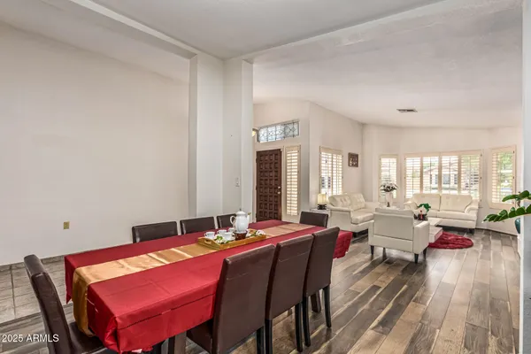 a living room with furniture a large window and a table
