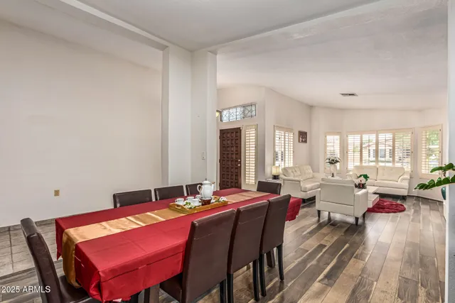 a living room with furniture a large window and a table