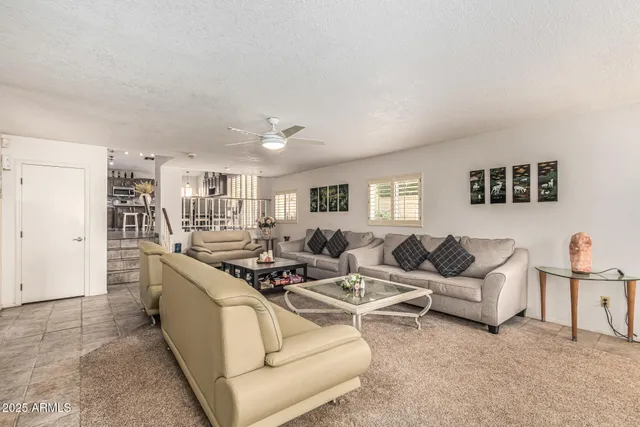 a living room with furniture white walls and white walls