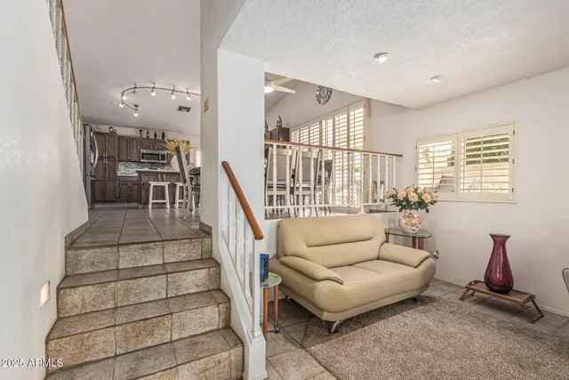a living room with furniture a wooden floor and a large window