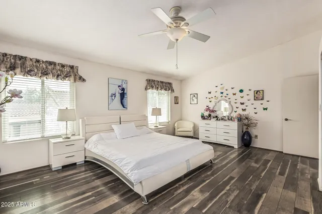 a bedroom with a large bed and a chandelier