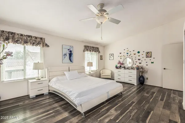 a bedroom with a large bed and a chandelier