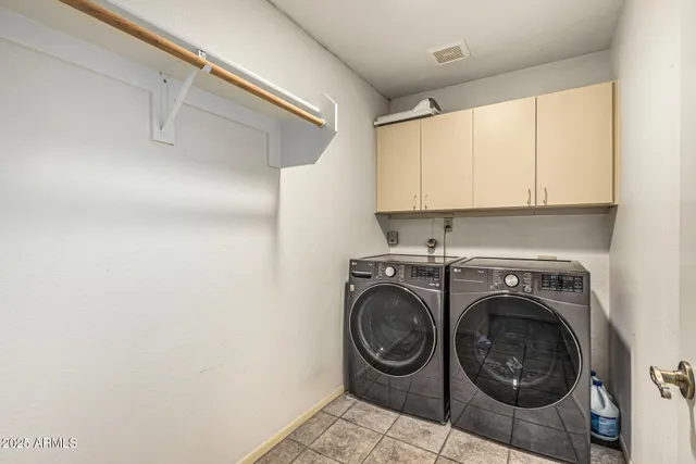 a utility room with sink dryer and washer