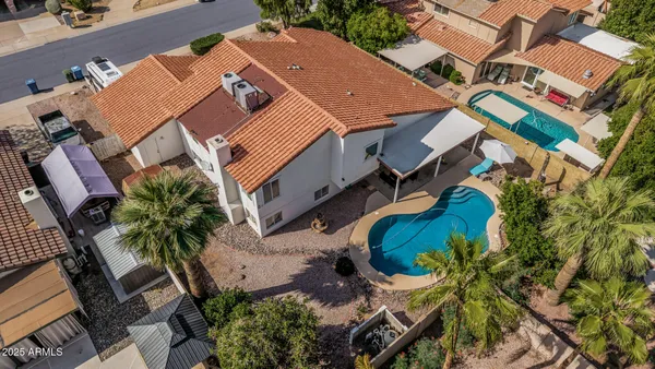 an aerial view of a house with a yard and trees
