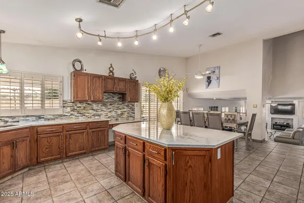 a kitchen with stainless steel appliances granite countertop a sink and a refrigerator