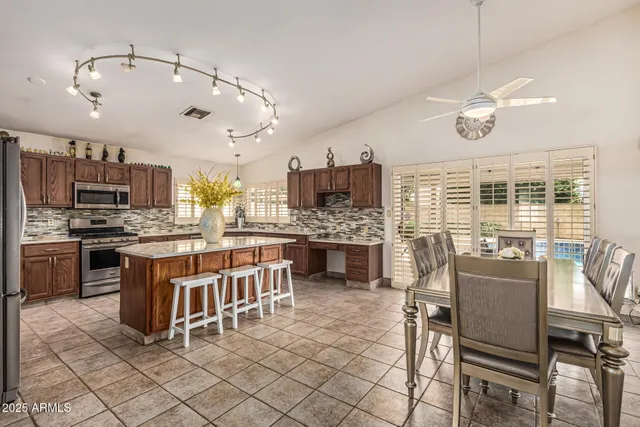 a large kitchen with a table and chairs