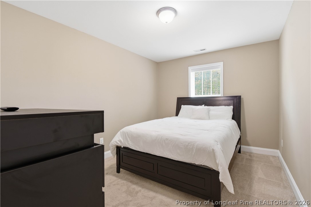 140 Birch Avenue Spring Lake, NC 28390 - Photo 38 of 49 a bedroom with a bed and a window