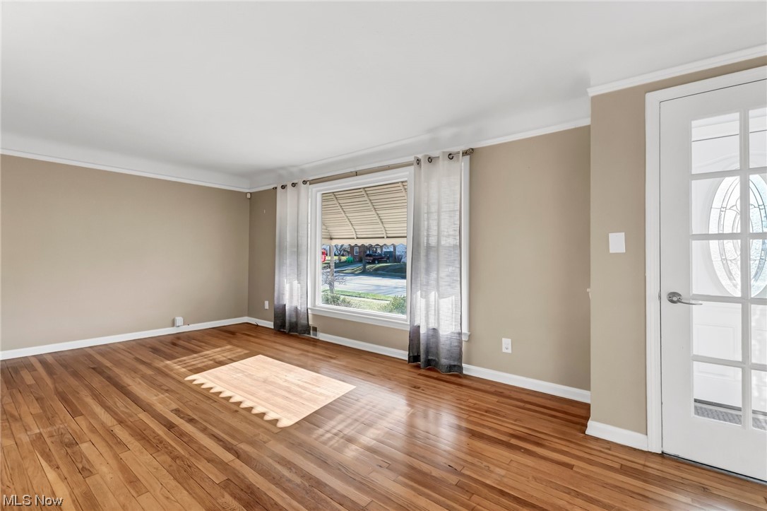 9516 Snow Road Cleveland, OH 44130 - Photo 13 of 40 Living room with crown molding and wood-type flooring