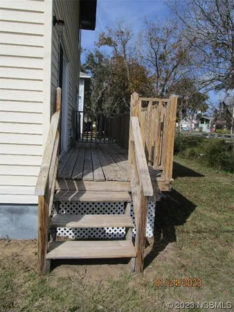a view of stairs with wooden fence