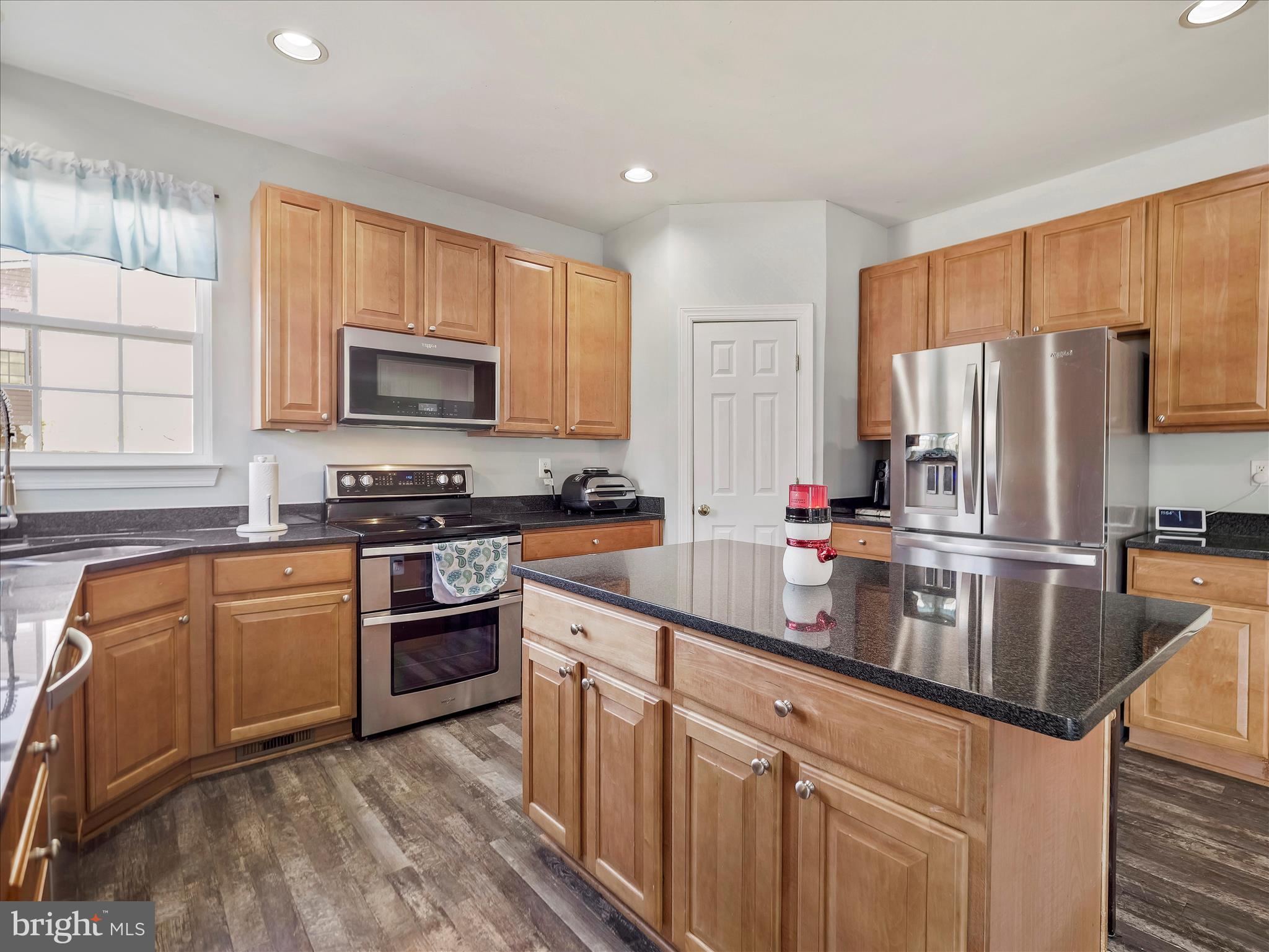 8935 Harper Drive Waynesboro, PA 17268 - Photo 11 of 46 a kitchen with stainless steel appliances granite countertop a refrigerator stove microwave and sink
