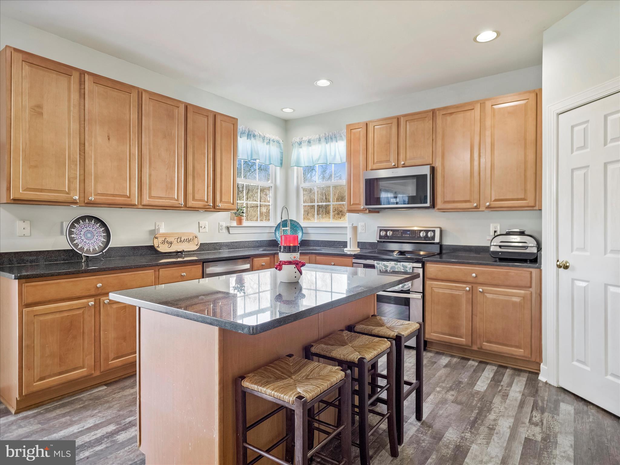 8935 Harper Drive Waynesboro, PA 17268 - Photo 10 of 46 a kitchen with stainless steel appliances granite countertop a stove top oven a sink dishwasher and cabinets with wooden floor