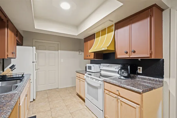a kitchen with stainless steel appliances granite countertop a sink stove and cabinets