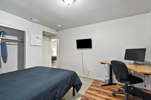 a bedroom with a bed and a flat screen tv