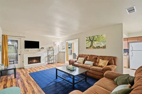 a living room with furniture flat screen tv and a fireplace