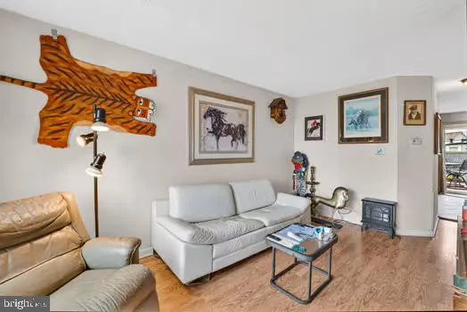 a living room with furniture a couch and wooden floor