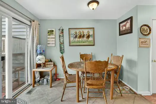 a view of a dining room with furniture and a window