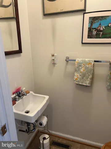 a bathroom with a sink and mirror