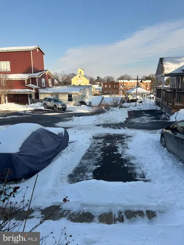a living room with furniture and a kitchen