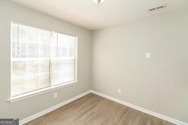 a kitchen with granite countertop a sink stove and refrigerator