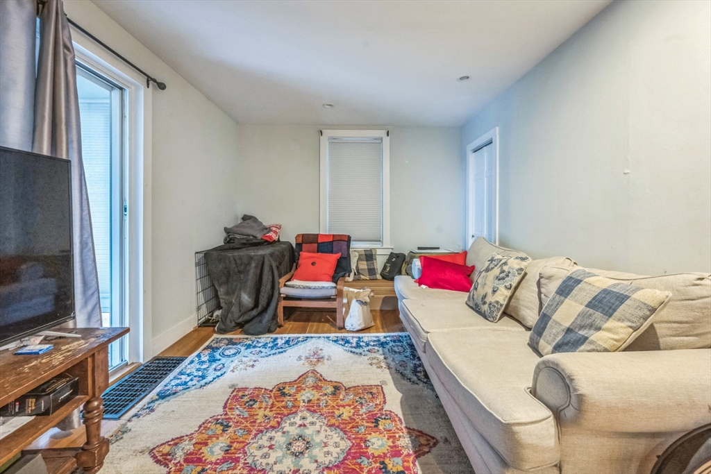 67 Meadow Street Framingham, MA 01701 - Photo 12 of 15 a living room with a couch and a flat screen tv