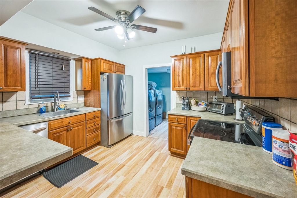 67 Meadow Street Framingham, MA 01701 - Photo 3 of 15 a kitchen with stainless steel appliances granite countertop a refrigerator a sink dishwasher stove and oven