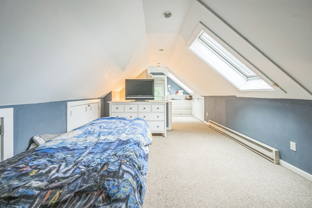 67 Meadow Street Framingham, MA 01701 - Photo 5 of 15 a bedroom with a bed and a flat tv screen