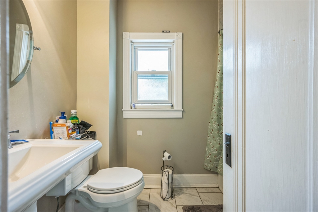 67 Meadow Street Framingham, MA 01701 - Photo 7 of 15 a bathroom with a sink a toilet and shower