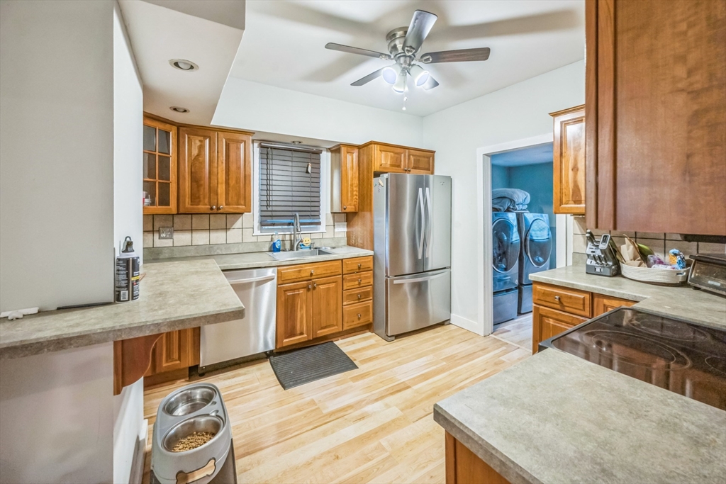 67 Meadow Street Framingham, MA 01701 - Photo 10 of 15 a kitchen with stainless steel appliances granite countertop a sink dishwasher stove and refrigerator