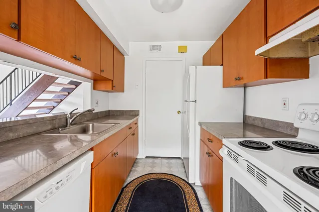 a kitchen with a stove and a refrigerator