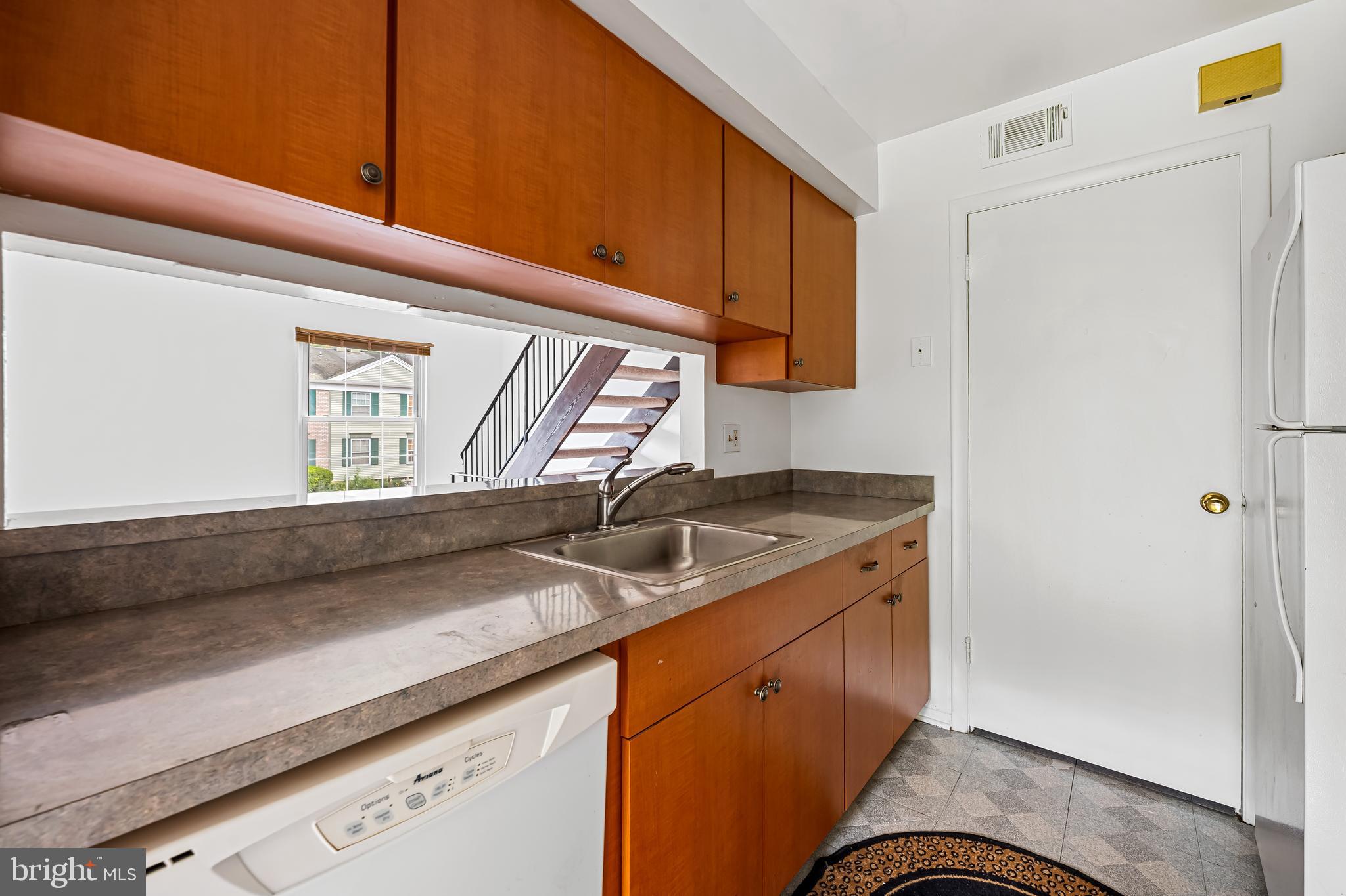 26 Mission Wood Way, Unit A Reisterstown, MD 21136 - Photo 14 of 29 a kitchen with a sink cabinets and a window