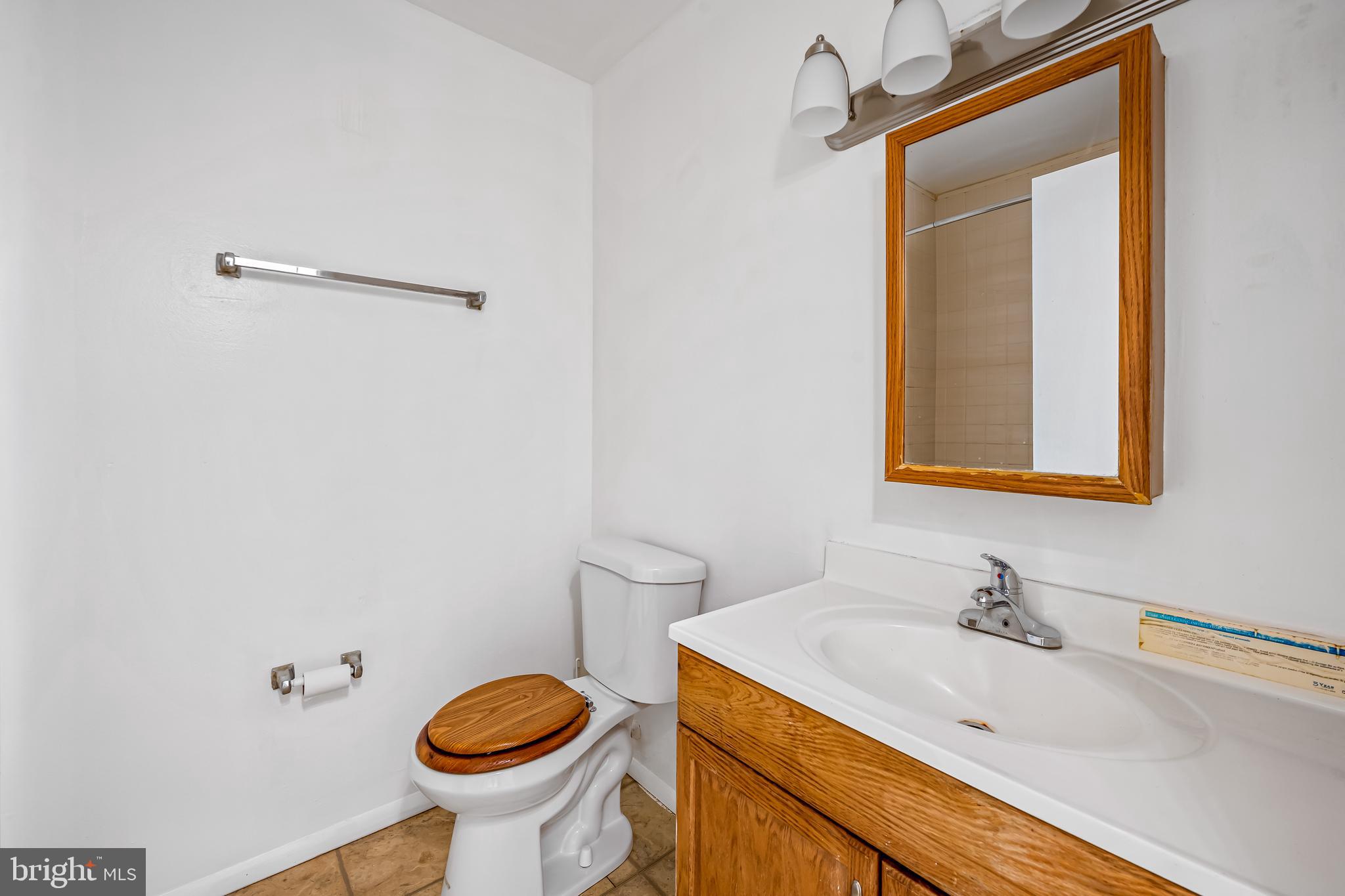 26 Mission Wood Way, Unit A Reisterstown, MD 21136 - Photo 23 of 29 a bathroom with a granite countertop sink and a toilet