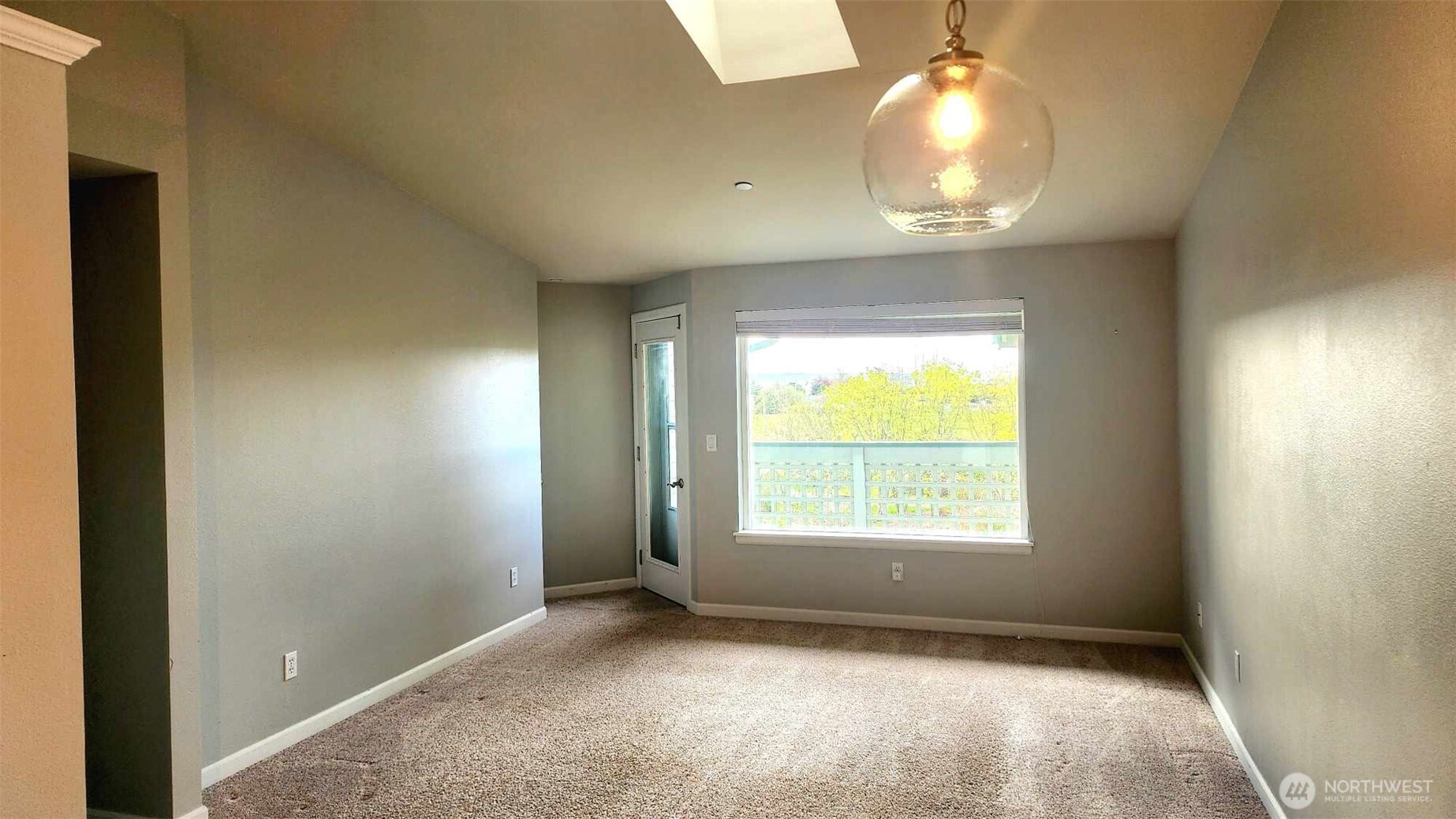 485 Southwest Bayshore Drive, Unit C301 Oak Harbor, WA 98277 - Photo 6 of 40 an empty room with a window and chandelier fan
